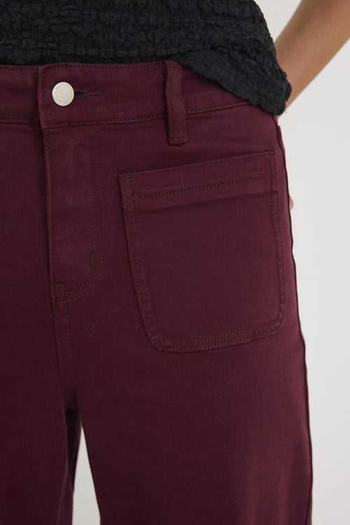 Maroon pants with a pocket on a white background