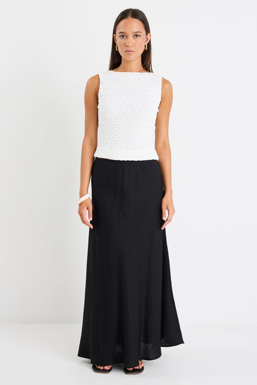 Woman wearing a black skirt and white top