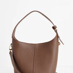 A brown pebbled leather shoulder bag with a top zipper and a detachable shoulder strap, shown on a clean white background.