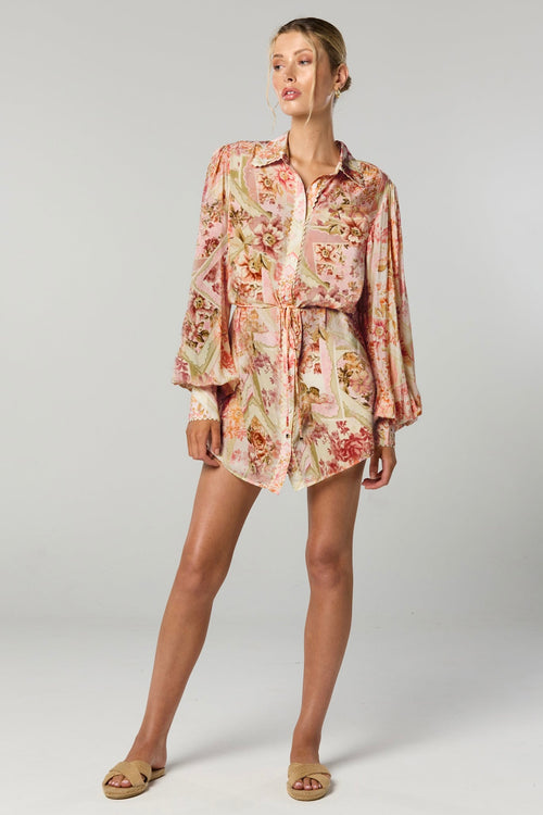 model wears a pink floral shirt mini dress