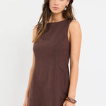 Woman wearing a brown dress on a white background