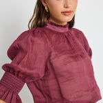 Model wears Burgundy top