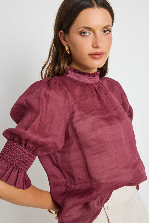 Model wears Burgundy top