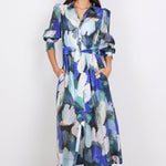 Woman wearing a long, blue patterned dress on a white background