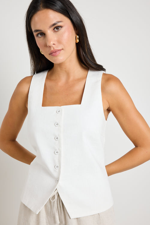 model wears a white linen vest