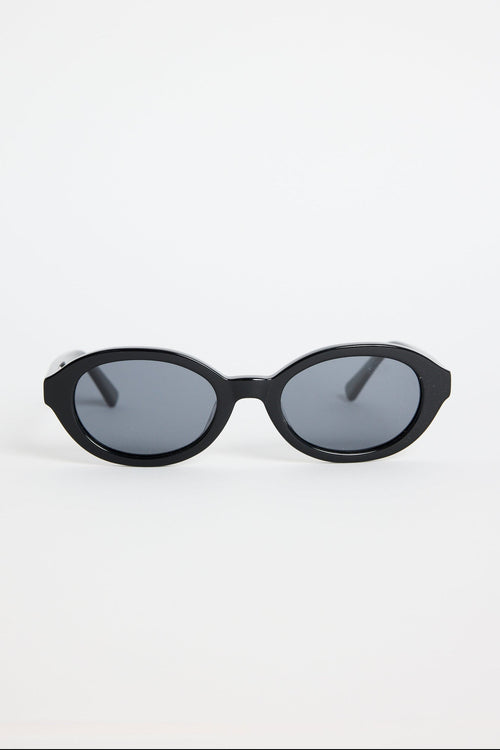Black sunglasses with dark lenses on a white background