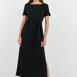 This black dress features a flattering side tie detail and a relaxed fit, perfect for both casual and dressy occasions.