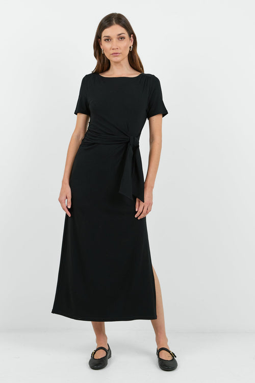This black dress features a flattering side tie detail and a relaxed fit, perfect for both casual and dressy occasions.
