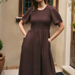 Woman wears a chocolate brown dress