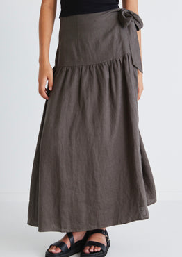 model wears a dark green linen maxi skirt