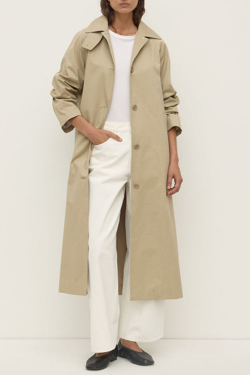 Woman wearing tan trench coat