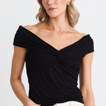 model wears a black off the shoulder top