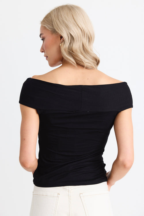 model wears a black off the shoulder top