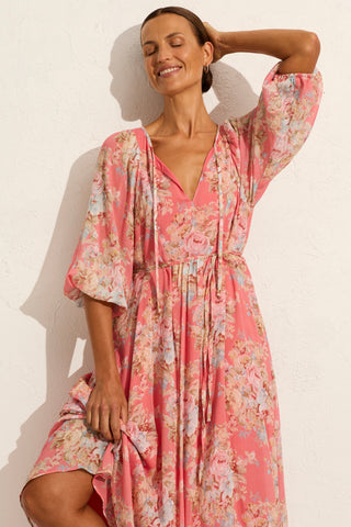 model wears a pink floral midi dress