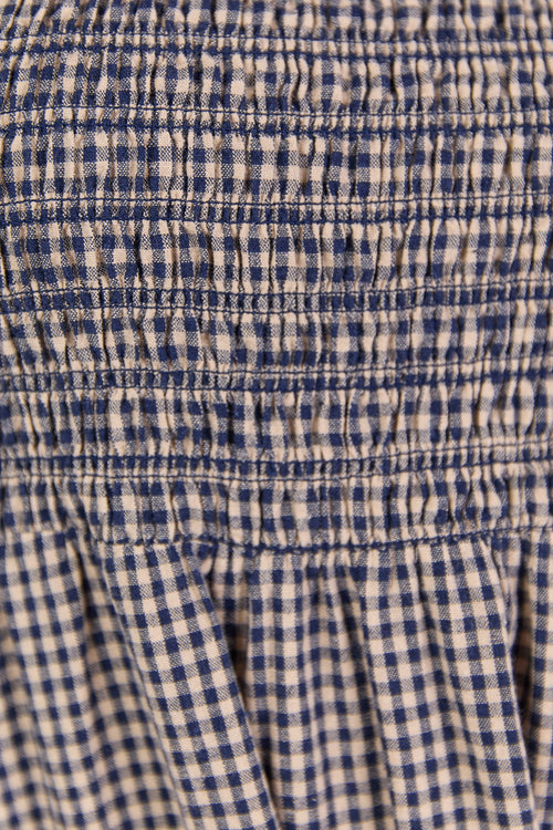 Close-up of a blue and white checkered fabric with a gathered waistband.