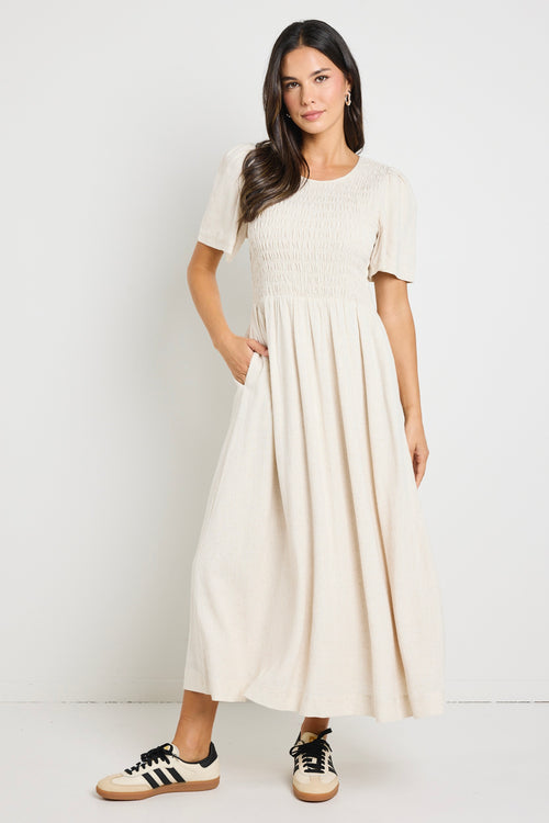 model wears a shirred natural maxi dress