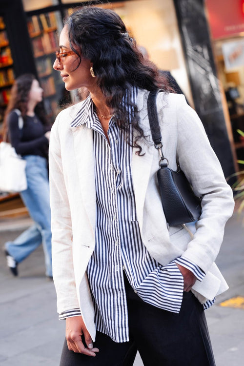 model wears a black and white stripe shirt 