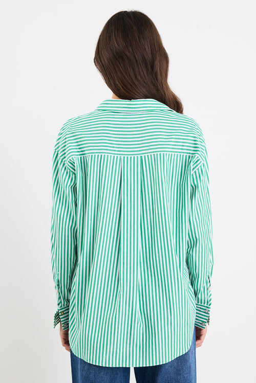 Person wearing a green and white striped shirt on a white background