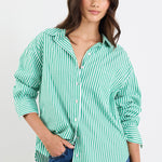 Woman wearing a green and white striped shirt with blue jeans on a white background