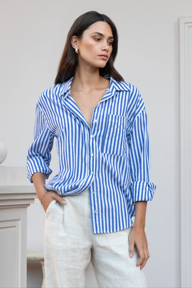 Model wearing a blue white striped shirt and beige pants