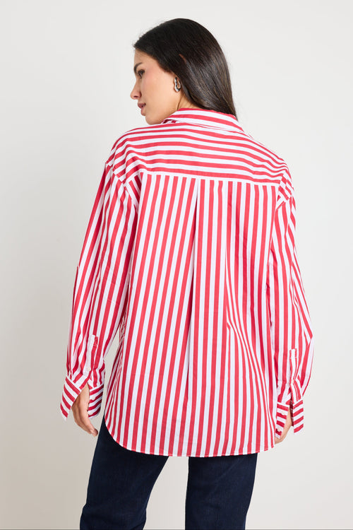 Woman wearing a red and white stripe oversized shirt 