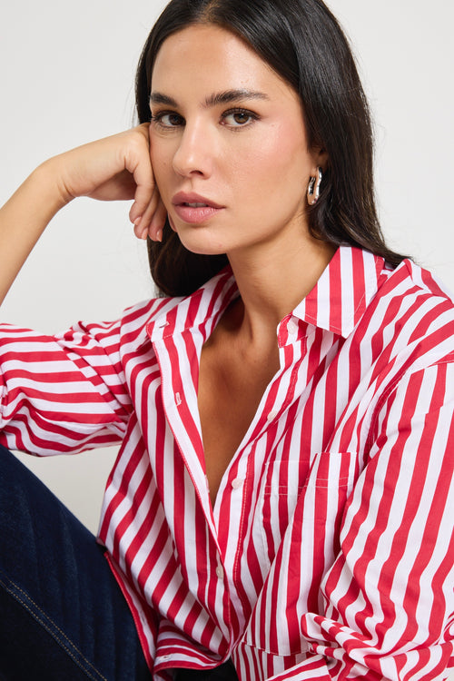 Woman wearing a red and white stripe oversized shirt 