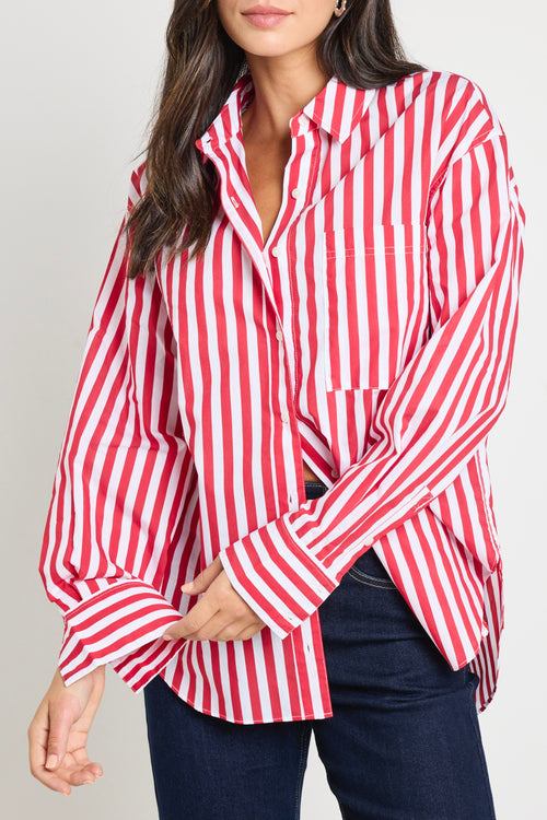 Woman wearing a red and white stripe oversized shirt 