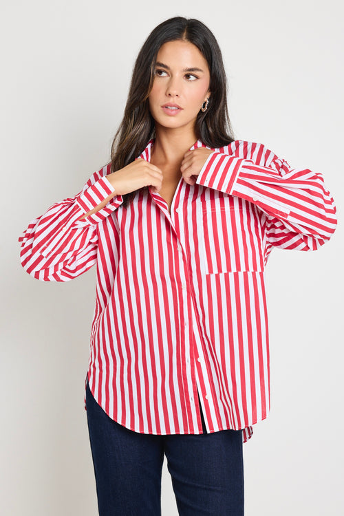 Woman wearing a red and white stripe oversized shirt 