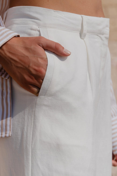 model wears white linen pants