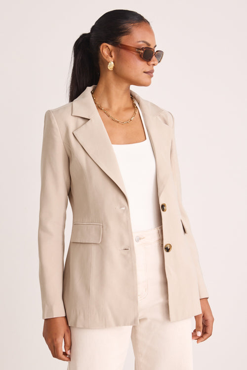 model wears a beige blazer