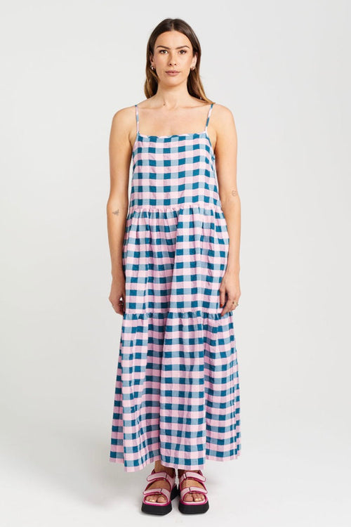 model wears blue and pink check maxi dress