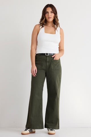 model wears green wide leg jeans