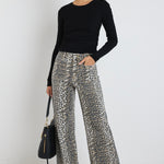 Model wears mid rise leopard print jean with front panel pockets 