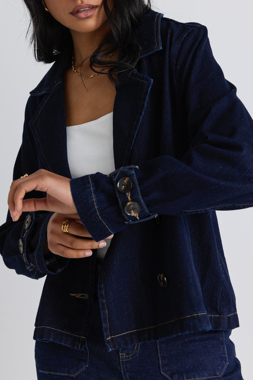 model wears a blue denim jacket