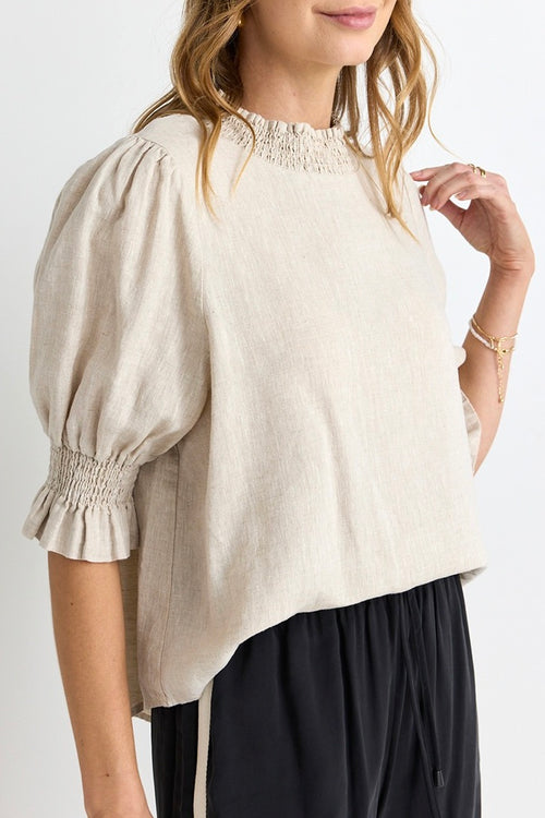 model wears a beige linen blouse