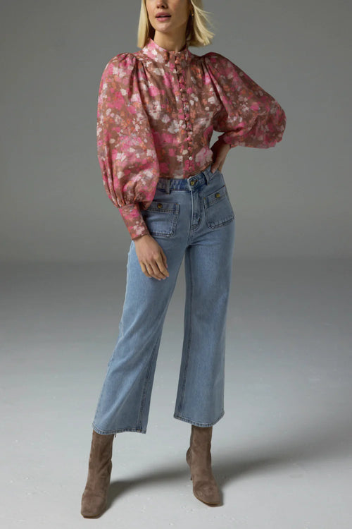 Model wears a pink blush floral high neck blouse