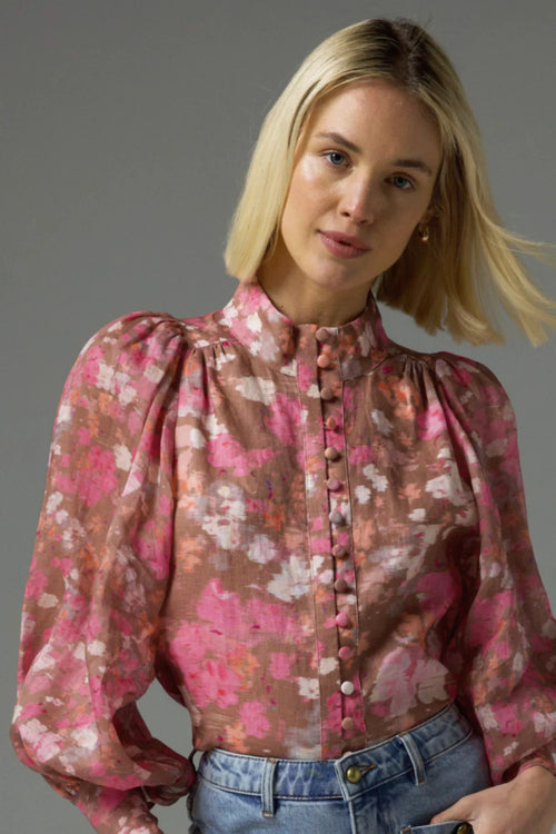 Model wears a pink blush floral high neck blouse