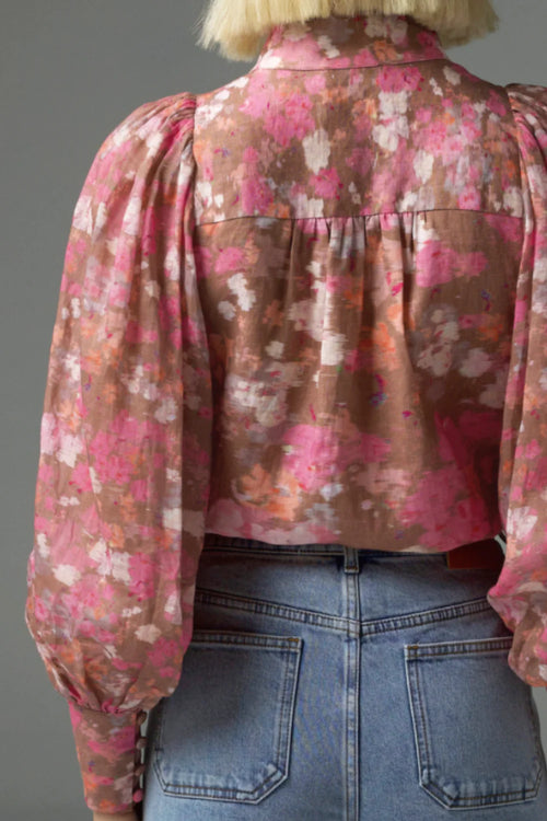 Model wears a pink blush floral high neck blouse