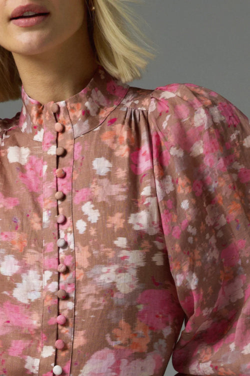 Model wears a pink blush floral high neck blouse