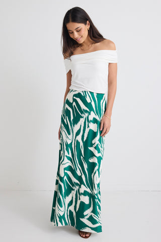 model wears a green print maxi skirt