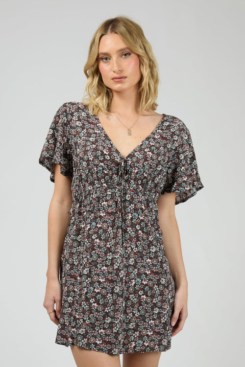 Woman wearing dark purple floral dress