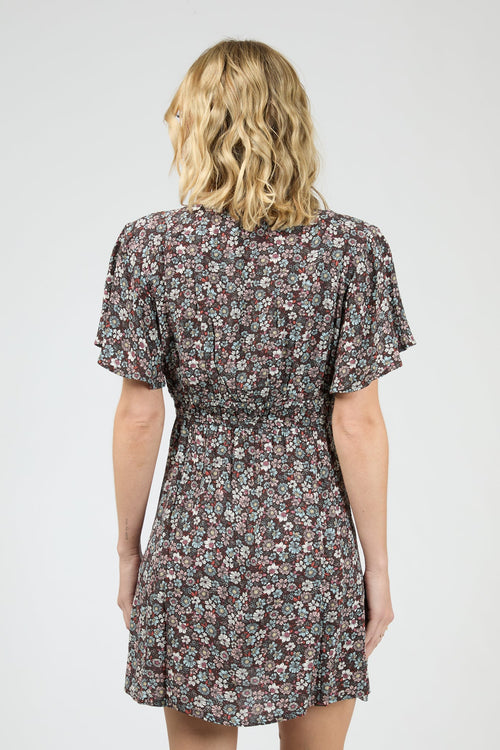 Woman wearing dark purple floral dress