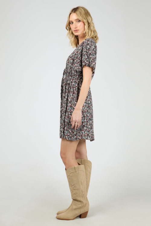 Woman wearing dark purple floral dress