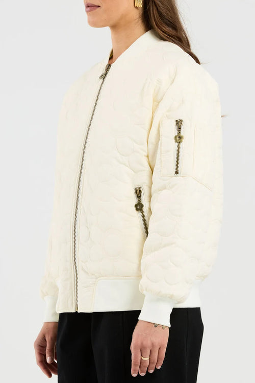 White bomber jacket worn by a person on a white background
