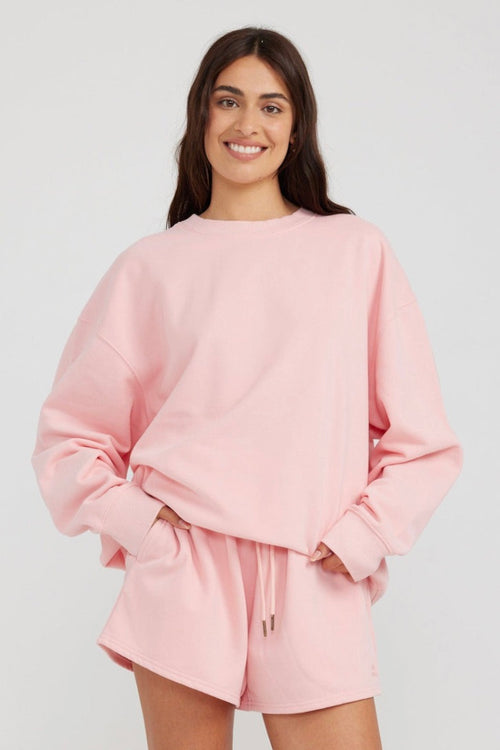 model wears a pink jumper