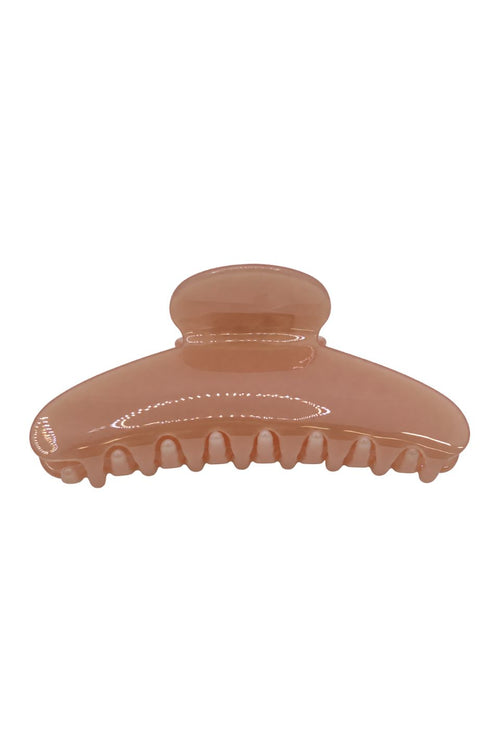 A translucent peach-colored hair claw clip on a solid white background.