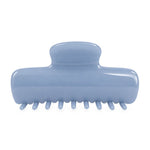 A light blue glossy hair claw clip with a curved handle and multiple small teeth along the bottom, shown on a plain white background.