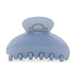 A translucent light blue hair claw clip on a solid white background.