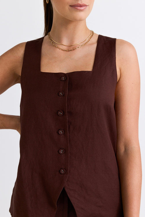 model wears a brown linen top