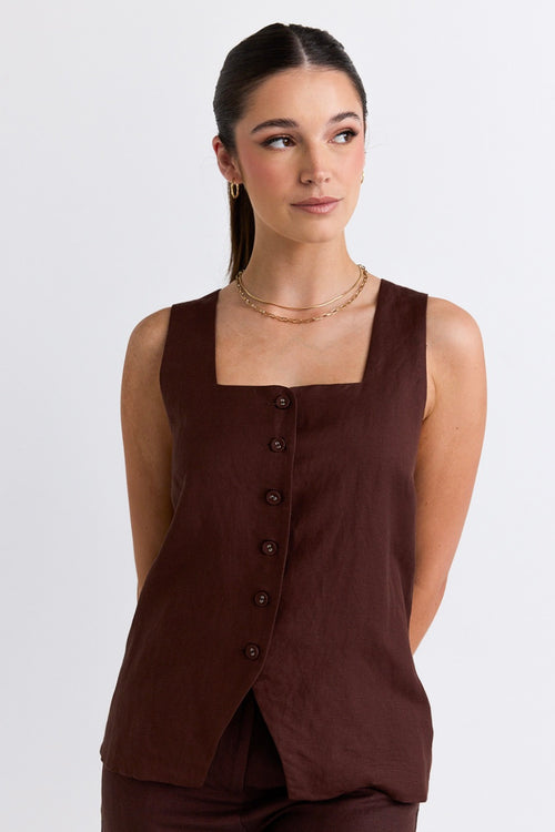 model wears a brown linen top